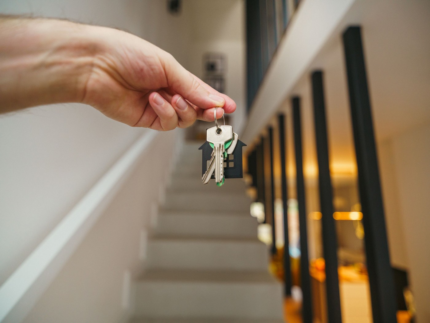House keys being handed over inside a modern home